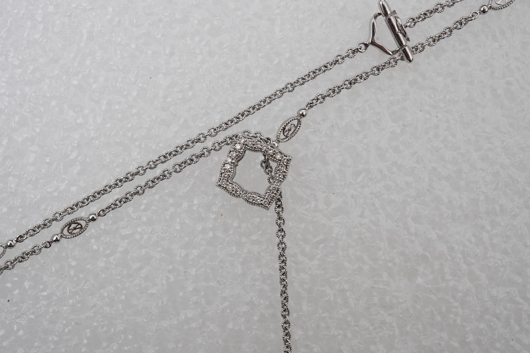 A diamond lariat necklace